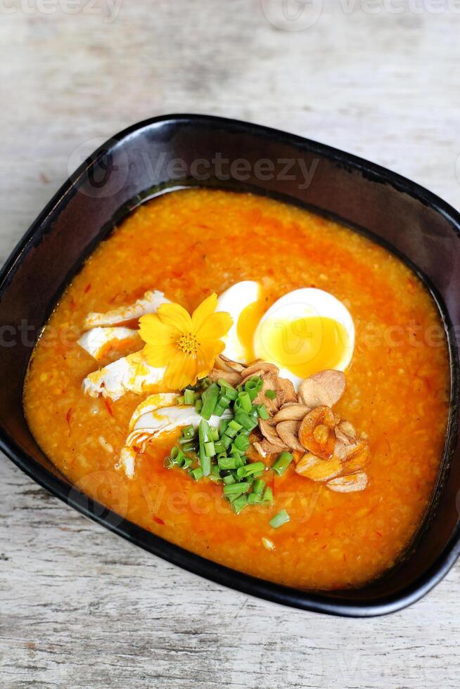 Big Bowl Arroz Caldo served in a bowl isolated on grey background side view of soup photo