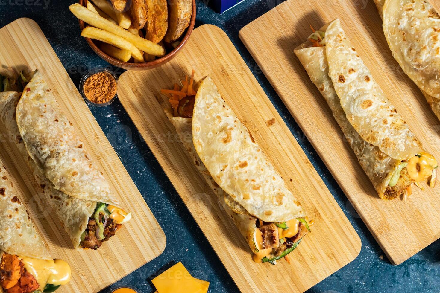 Beef Seekh Kabab shawarma, Chicken Afghani Kabab Wraps, Melt Cheese Paneer Wrap, Egg Cheesy Chicken Burger Wrap, Melt Cheese Chicken Wrap, Wedges and fries with salad dip and sauce isolated fastfood photo