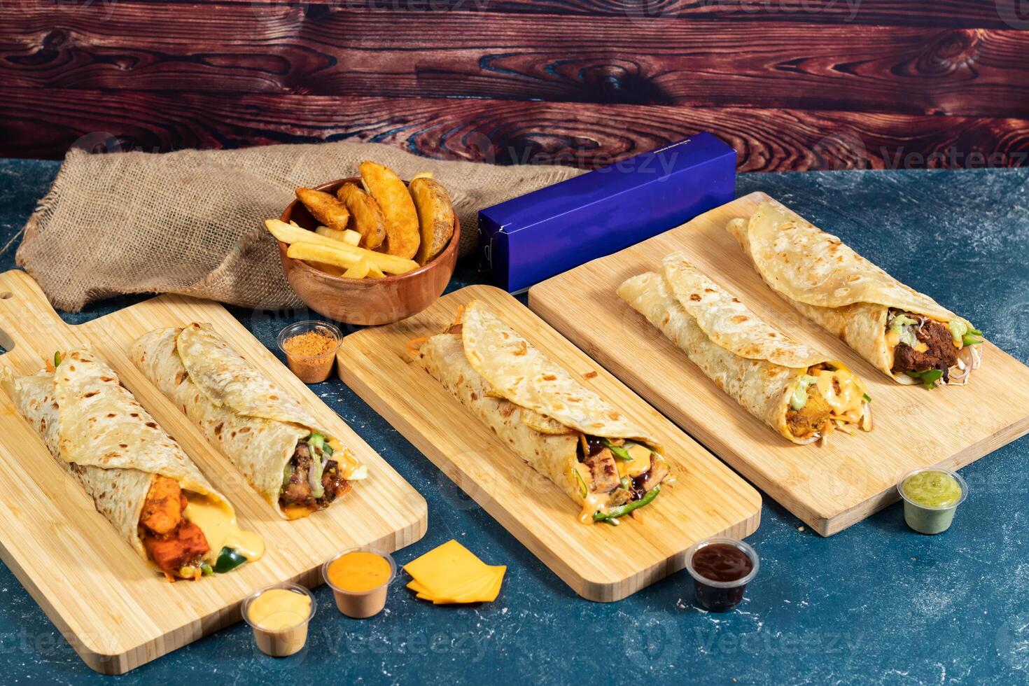 Beef Seekh Kabab shawarma, Chicken Afghani Kabab Wraps, Melt Cheese Paneer Wrap, Egg Cheesy Chicken Burger Wrap, Melt Cheese Chicken Wrap, Wedges and fries with salad dip and sauce isolated fastfood photo