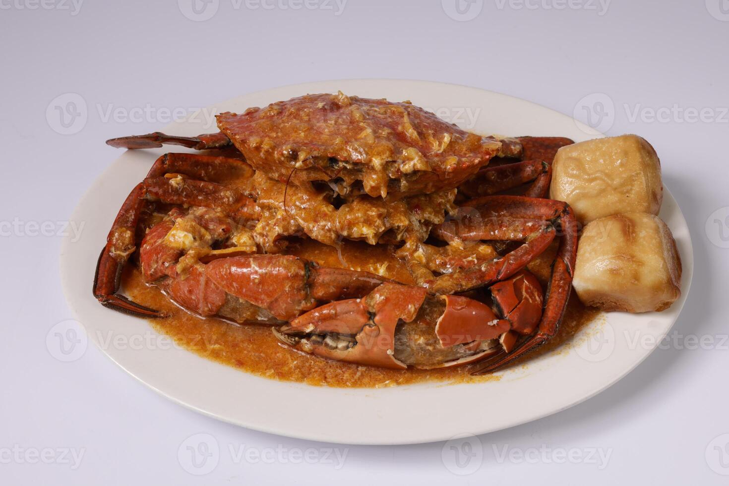 SINGAPOREAN CHILI CRAB with sauce in a dish top view on grey background singapore food photo