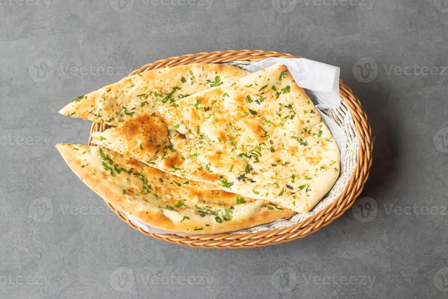 Tandoori Green Garlic Naan or bread served in basket isolated on table top view of asian and indian food photo