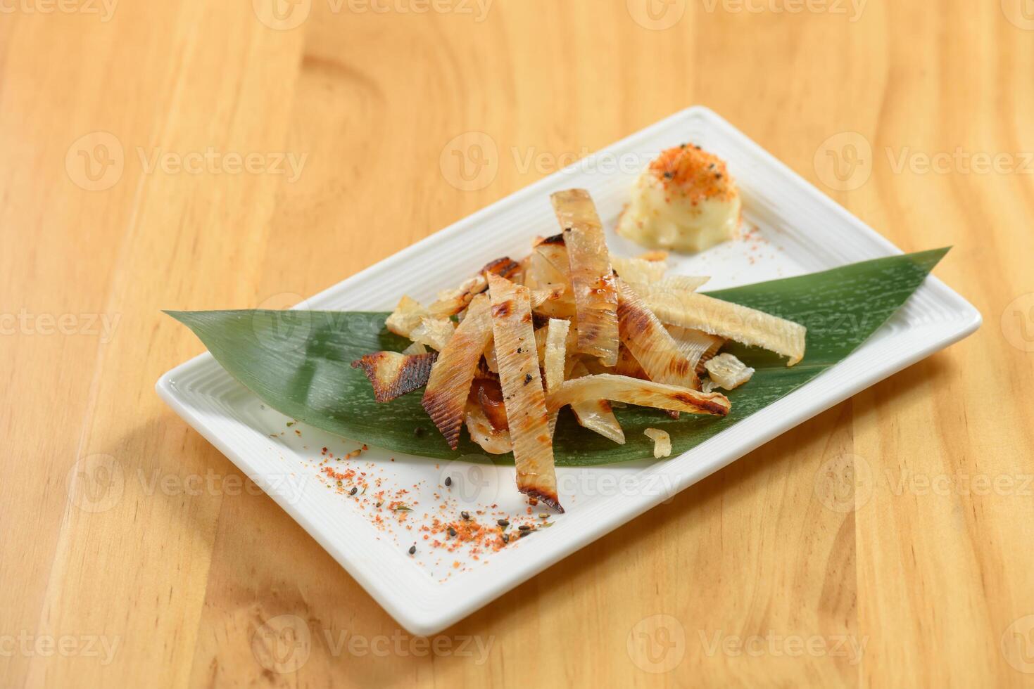 Fried Ei Hire on banana leaf on white tray isolated on wooden background top view photo