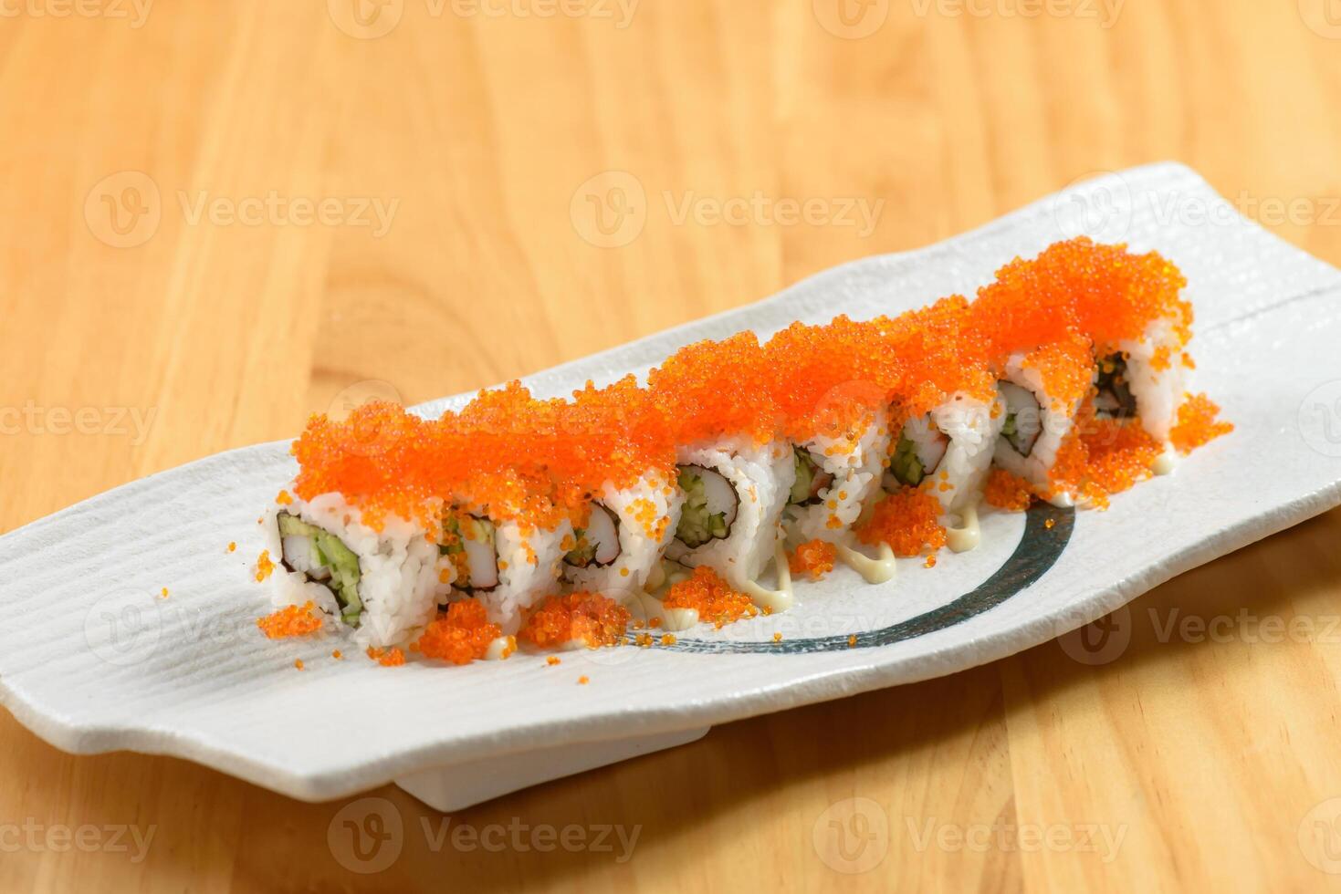 Japanese sushi food rainbow maki in a white tray isolated on wooden table top view photo