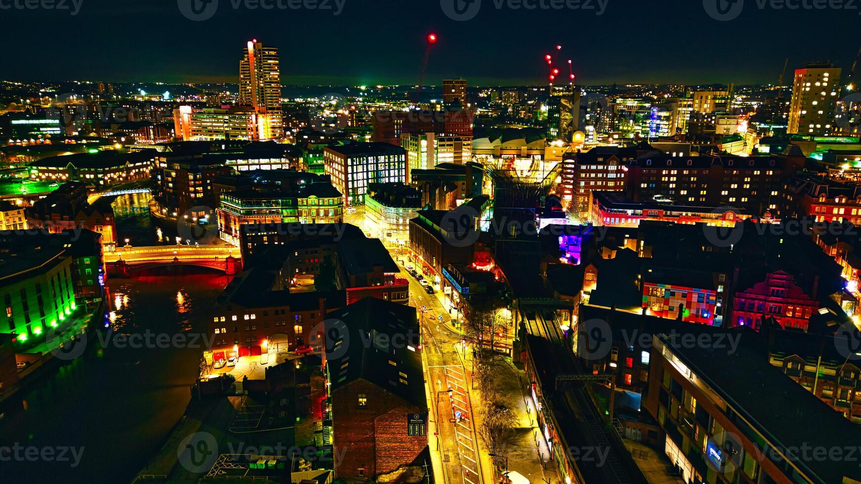 Panoramic night view of a bustling cityscape with illuminated streets and skyscrapers in Leeds, UK. photo
