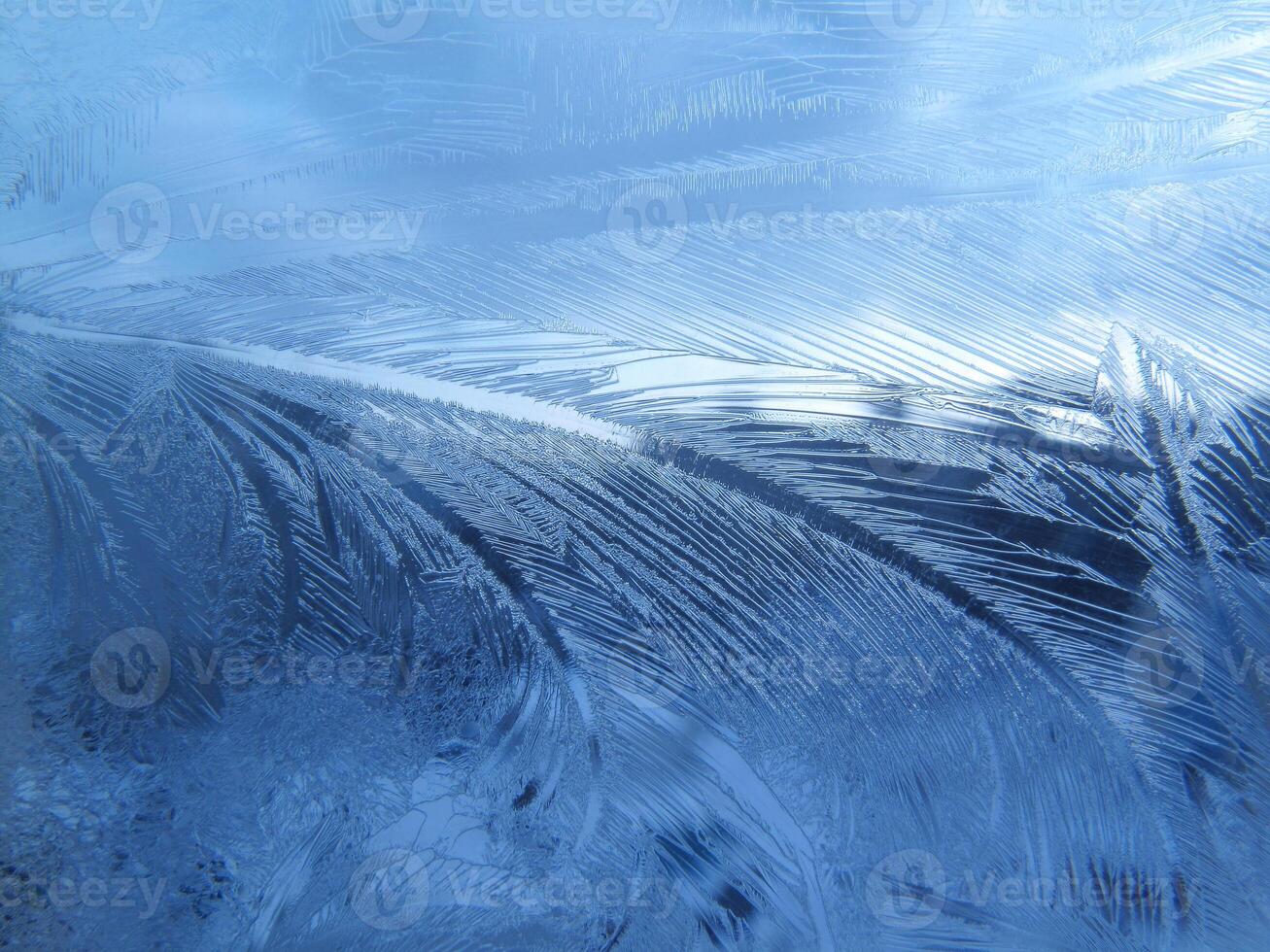 Ice natural pattern on glass, close-up winter background photo