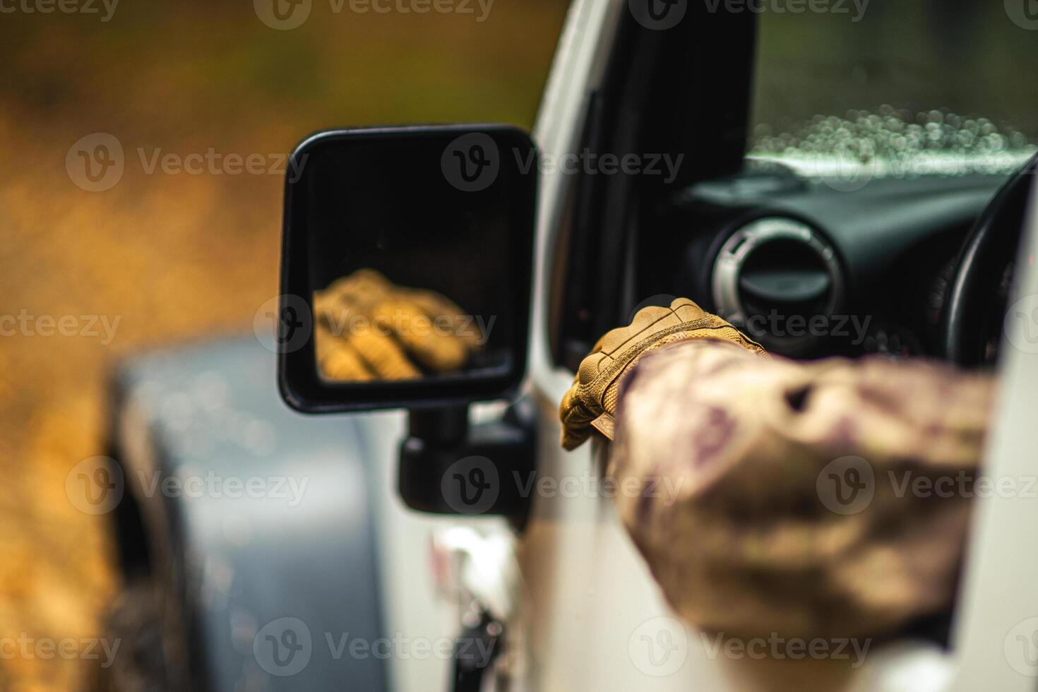 Hunter Driving Along Wilderness Looking For a Game photo