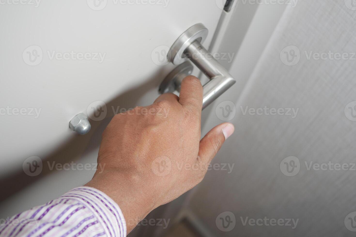 Man's Hand Opening door close up photo