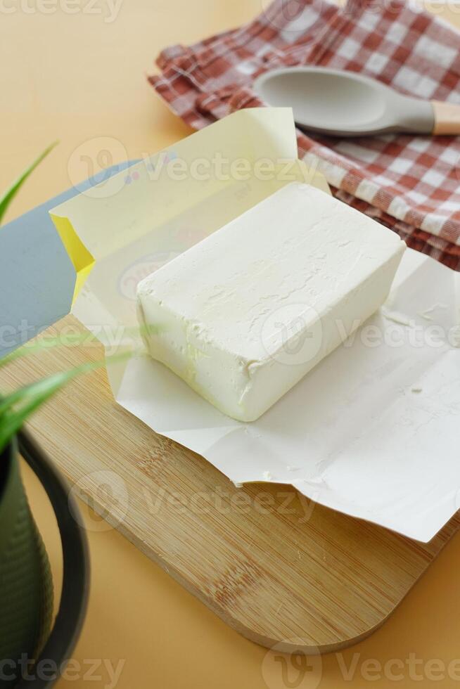 slice of a butter on a paper on table photo