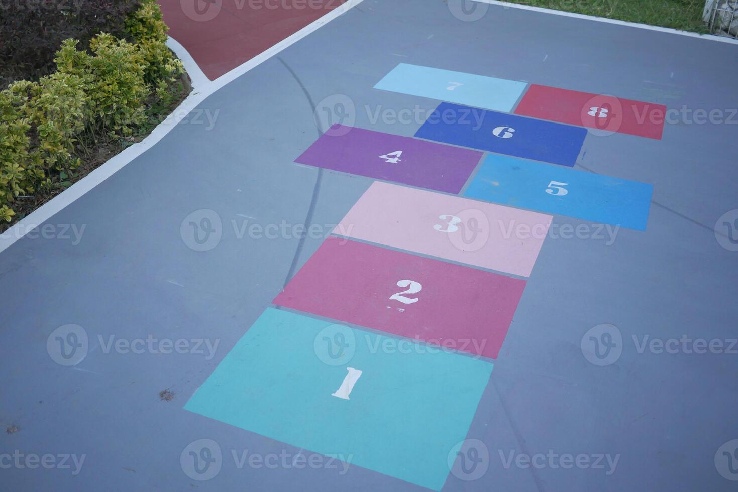 Vibrant hopscotch game painted on urban asphalt surface photo