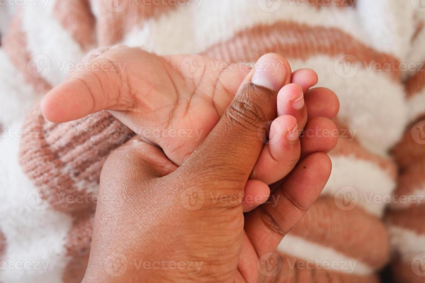 father holding hand of baby child, photo