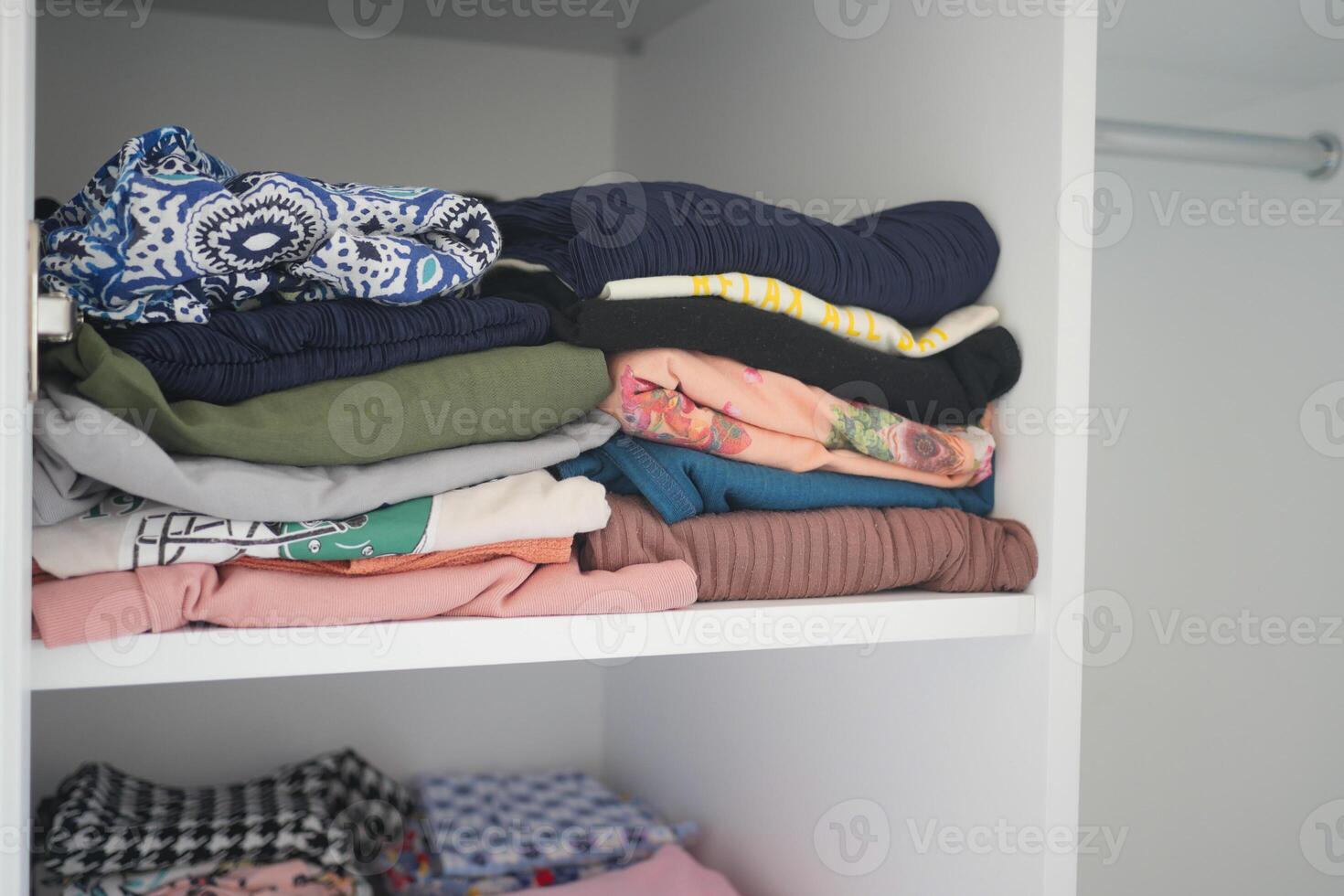 organizing clothes in a closet on shelves for comfort and ease of access photo