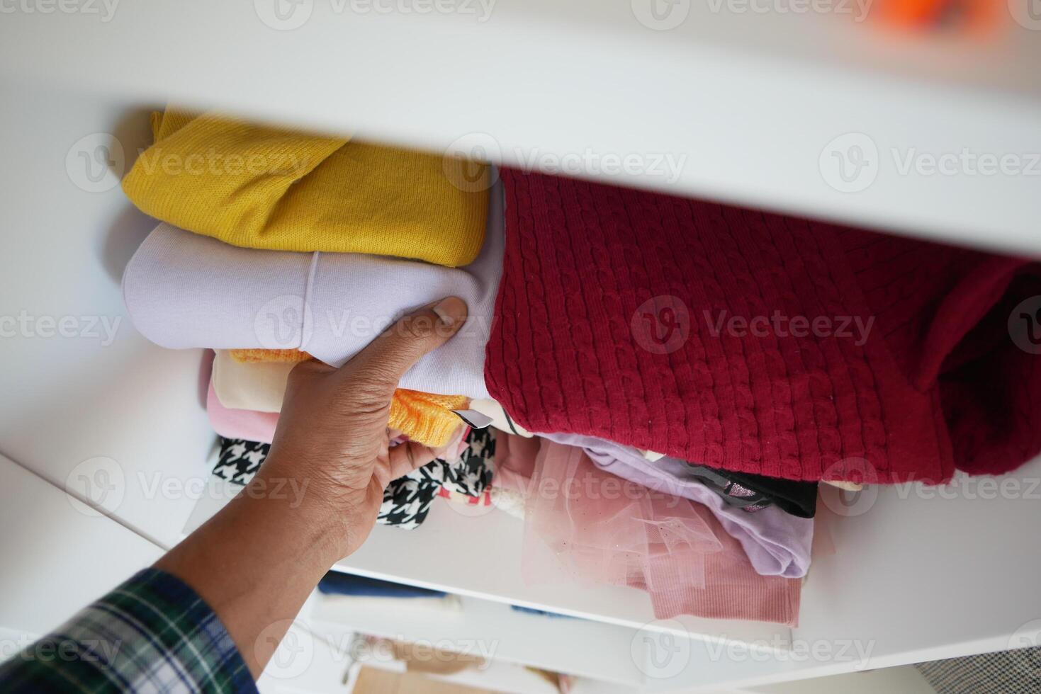 organizando ropa en un armario en estantería para comodidad y facilitar de acceso foto