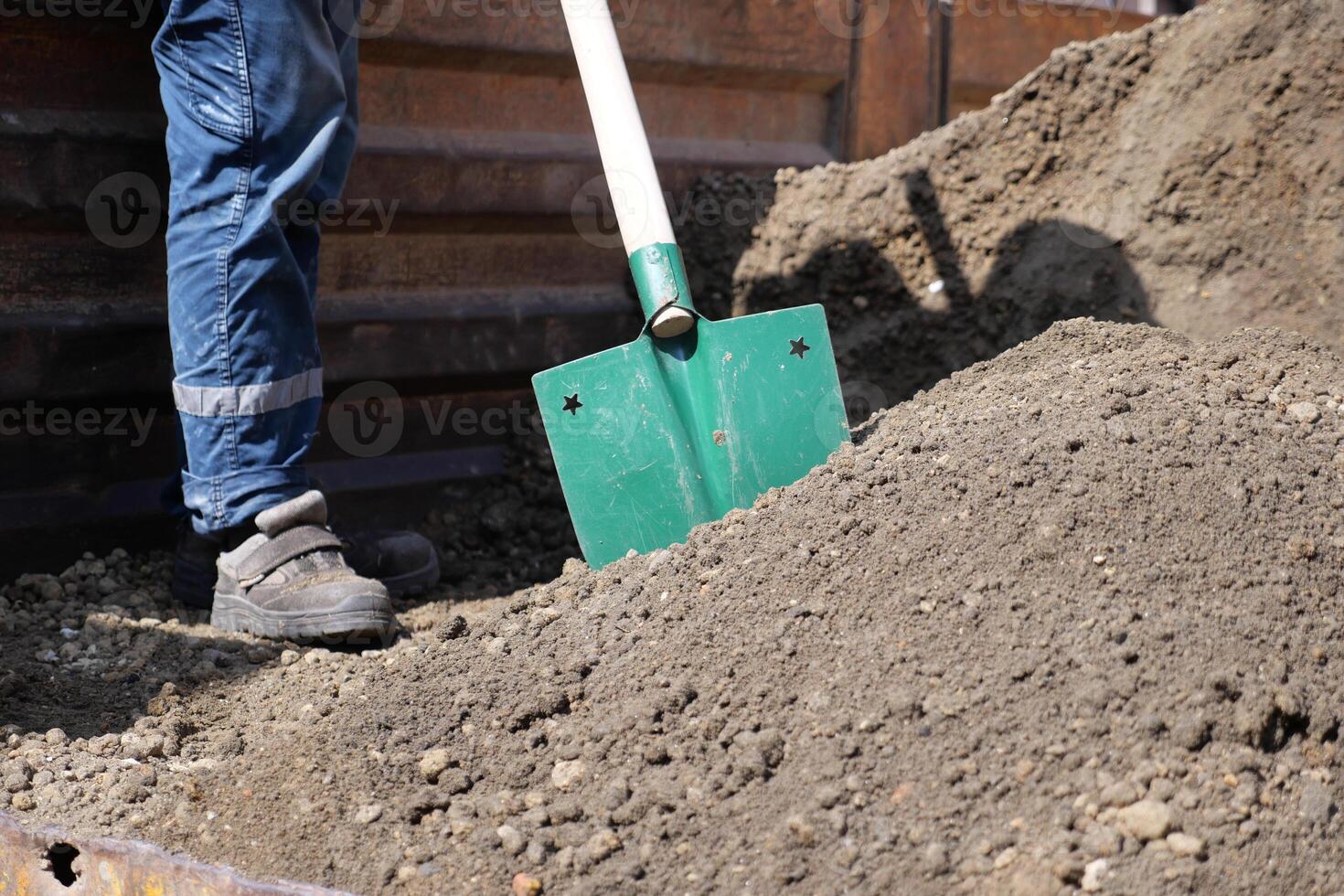 a man digs his spring garden with an old shovel. photo