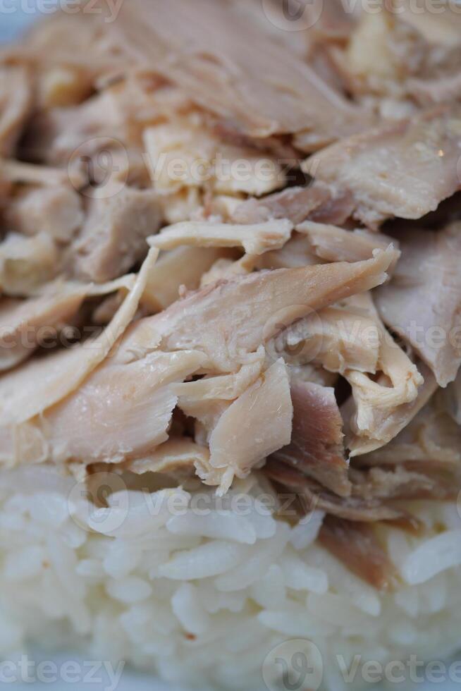 Boiled chicken, steamed rice, pink plate. photo