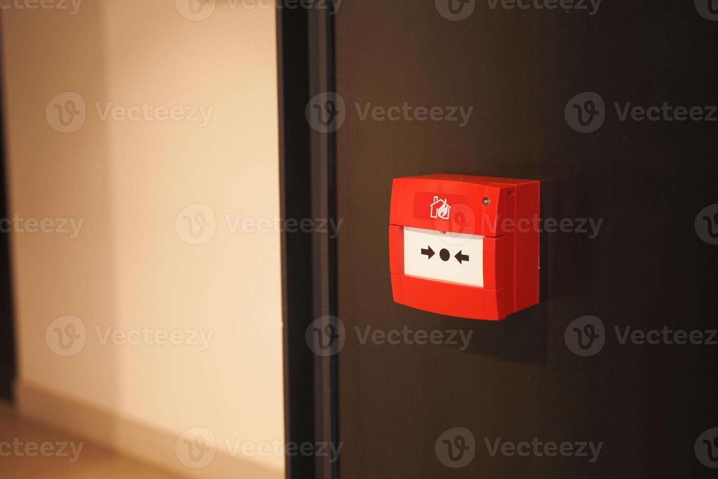 Red fire alarm button on wall , photo