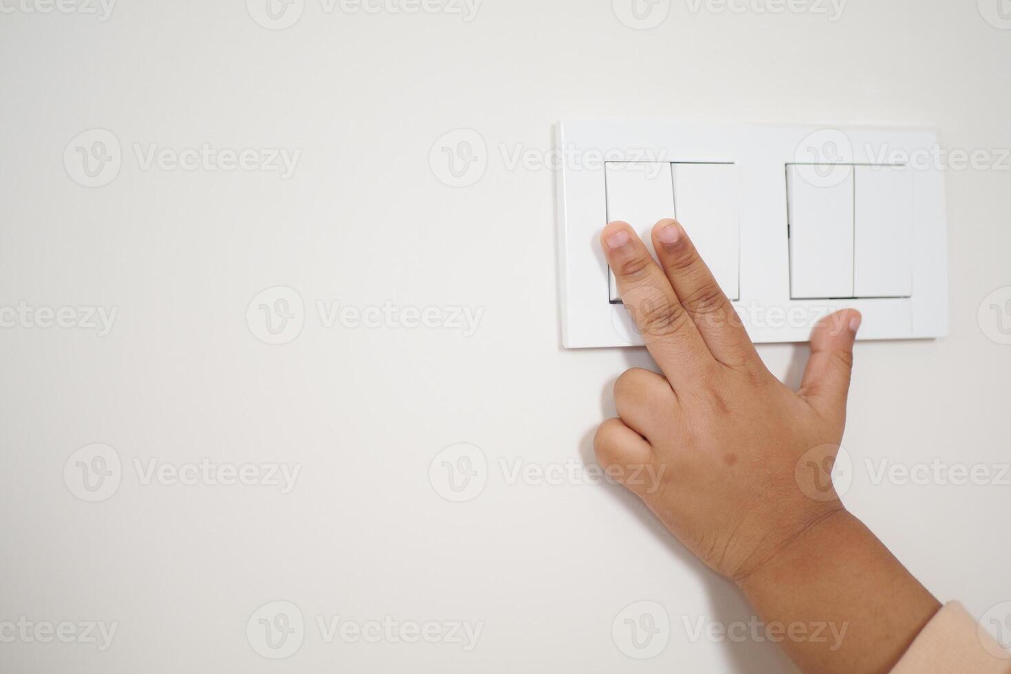 child finger turning on lighting switch with copyspace photo