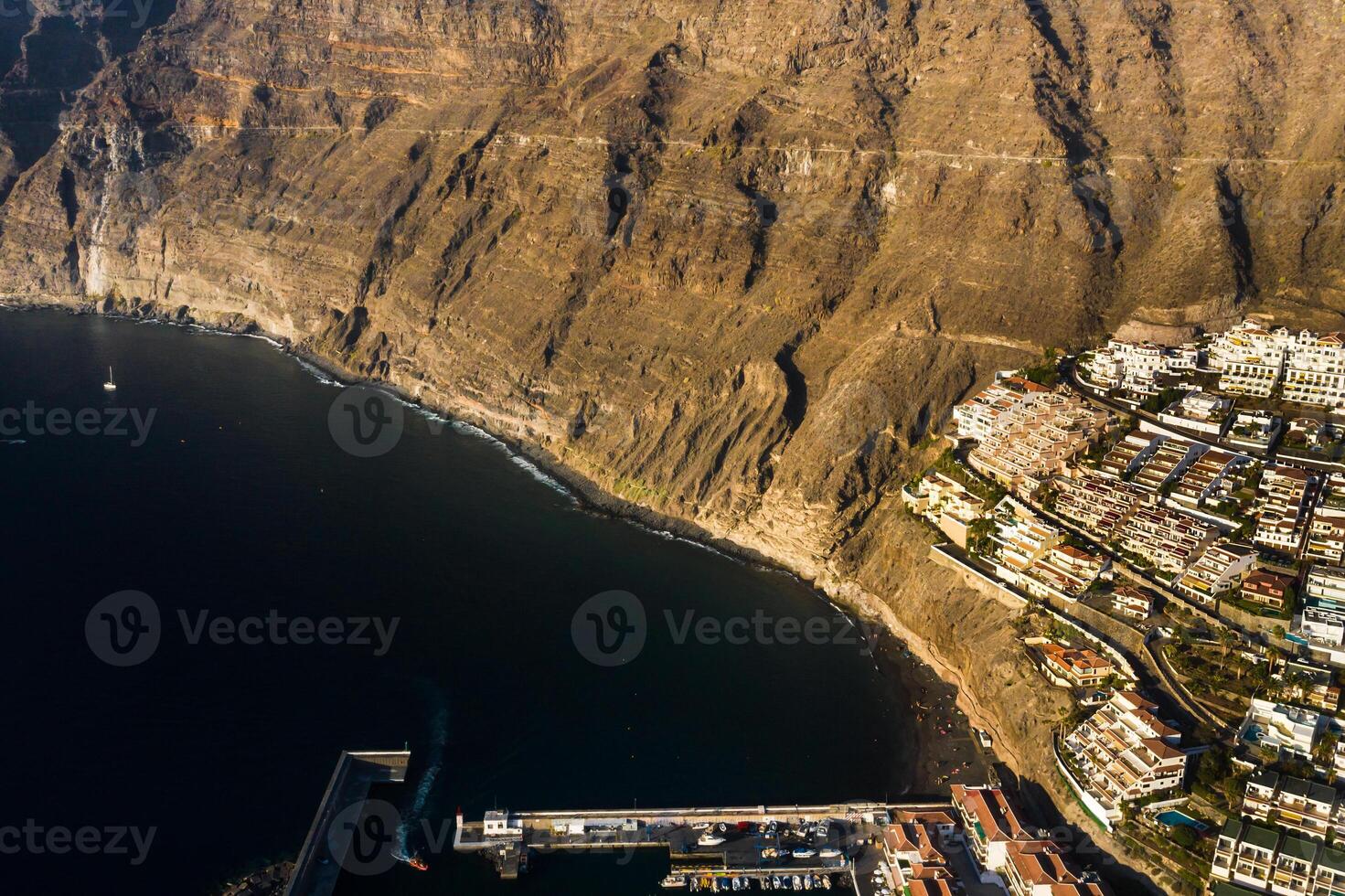 Top view of the houses located on the rock of Los Gigantes at sunset, Tenerife, Canary Islands, Spain photo