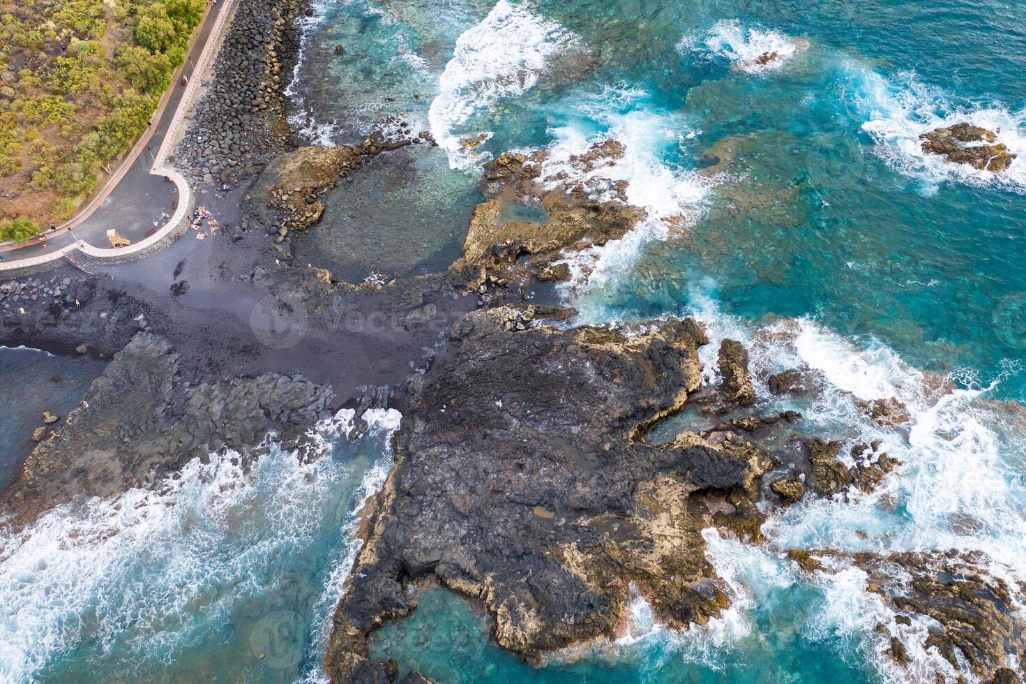 Rough rocky cliffs in the North of Tenerife.Black beach in the Canary Islands. Rocks, volcanic rocks, Atlantic ocean photo