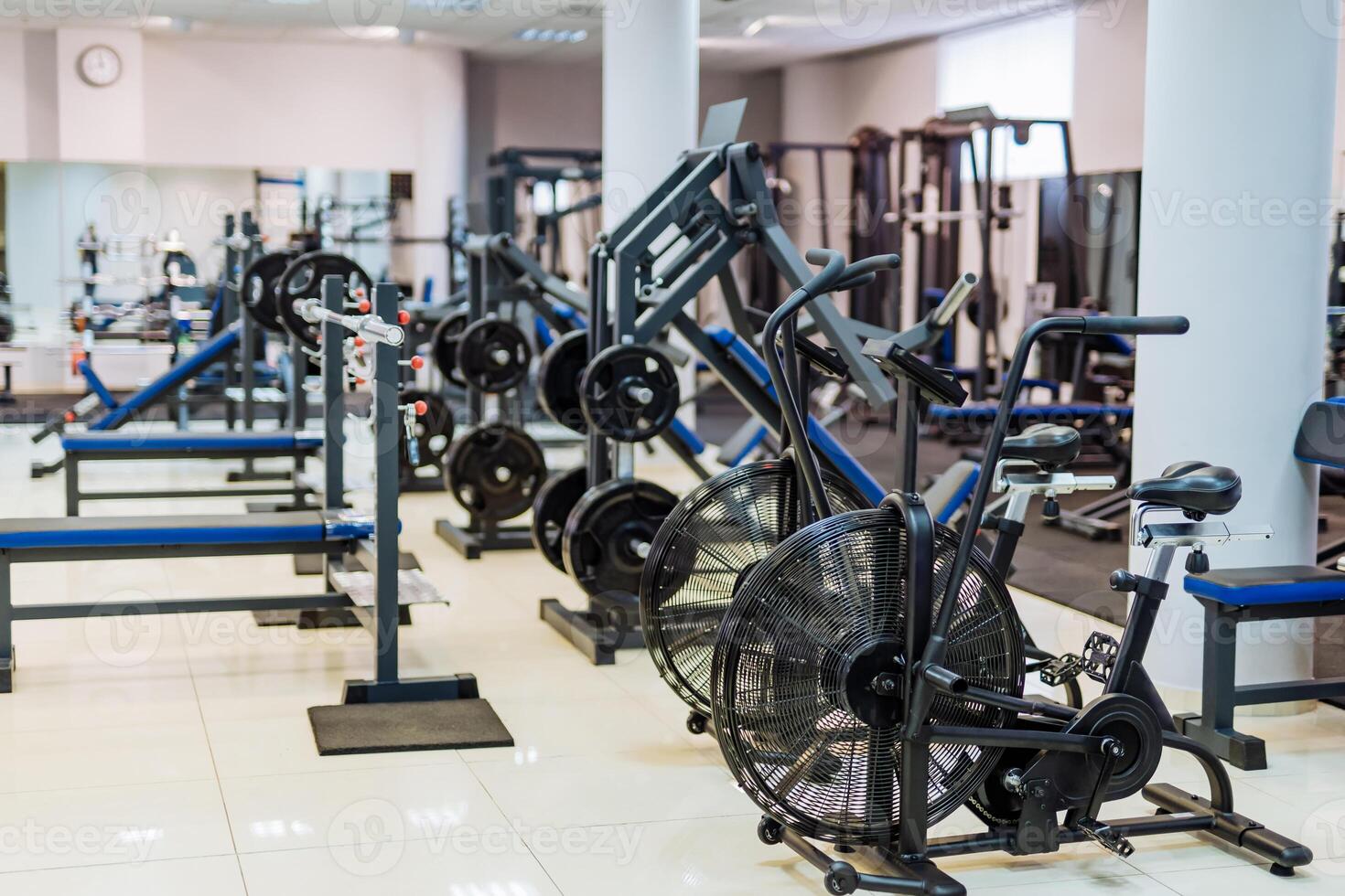 Fitness hall with sport bikes. Metal bicycle trainers, equipment in gym. photo