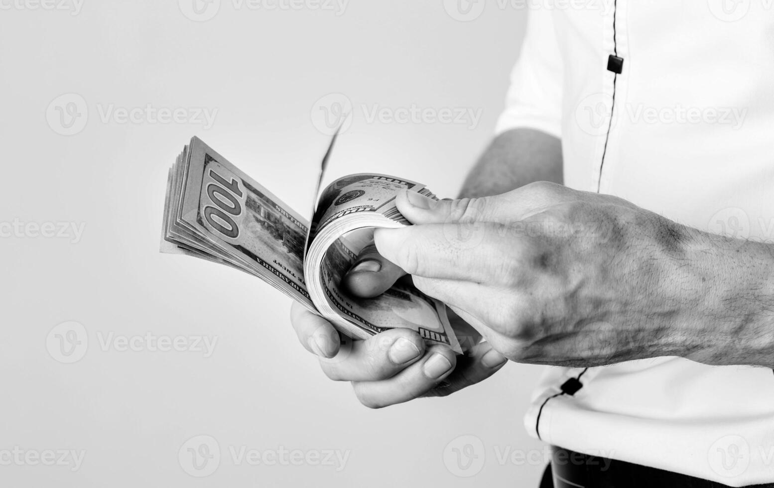 Businessman holds dollars in his hands. Rich man counts money in the room. photo