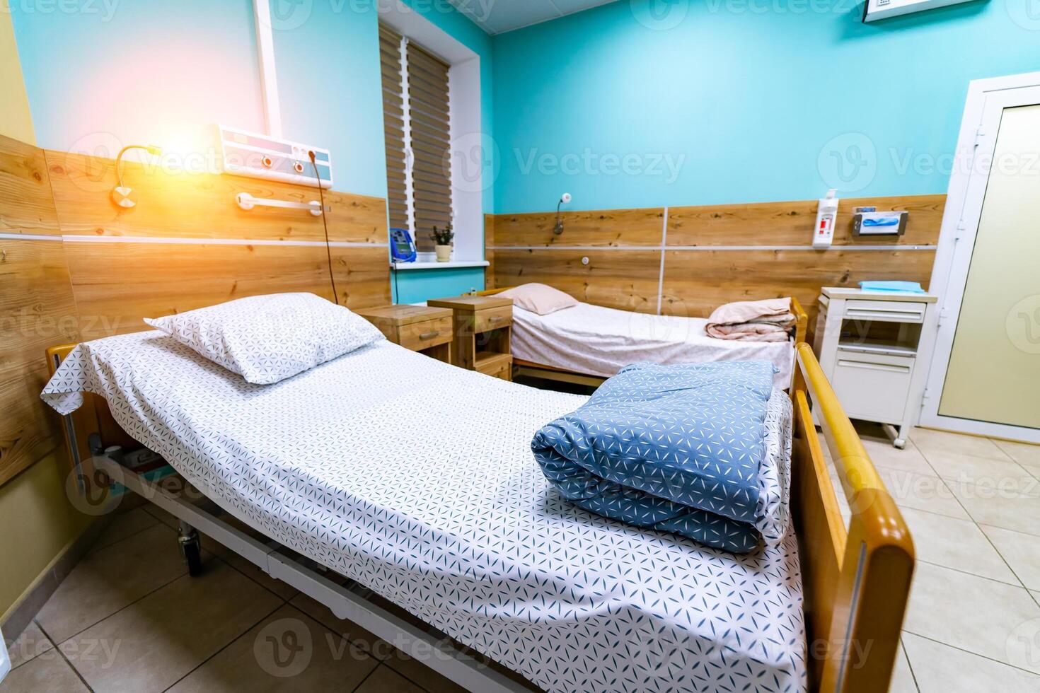 Comfortable medical facilities in a modern hospital. Bed in hospital room. photo