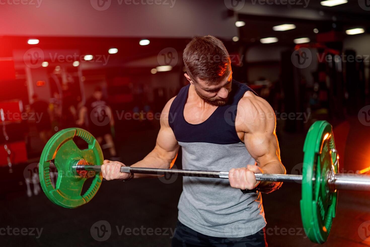 Strong muscle male lifting big weights. Sporty fitness man working out in the gym. photo