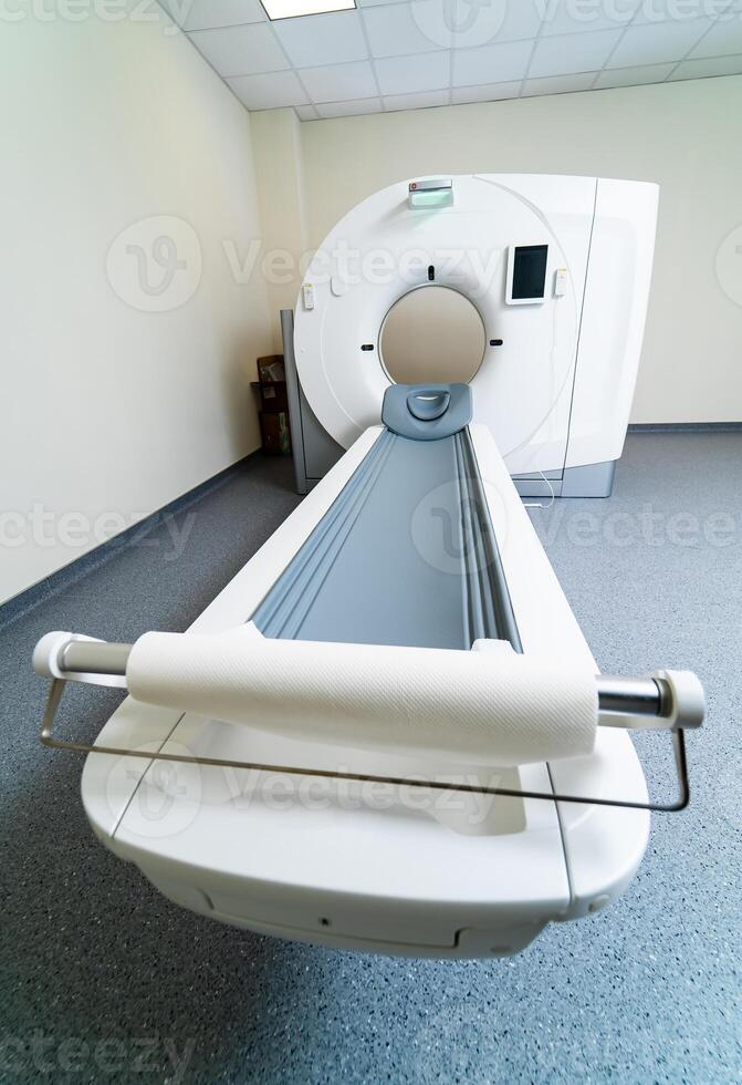 Examination table of a MRI scanner. Newest CT, MRI scanner in a modern hospital room. Clinic with up-to-date equipment photo