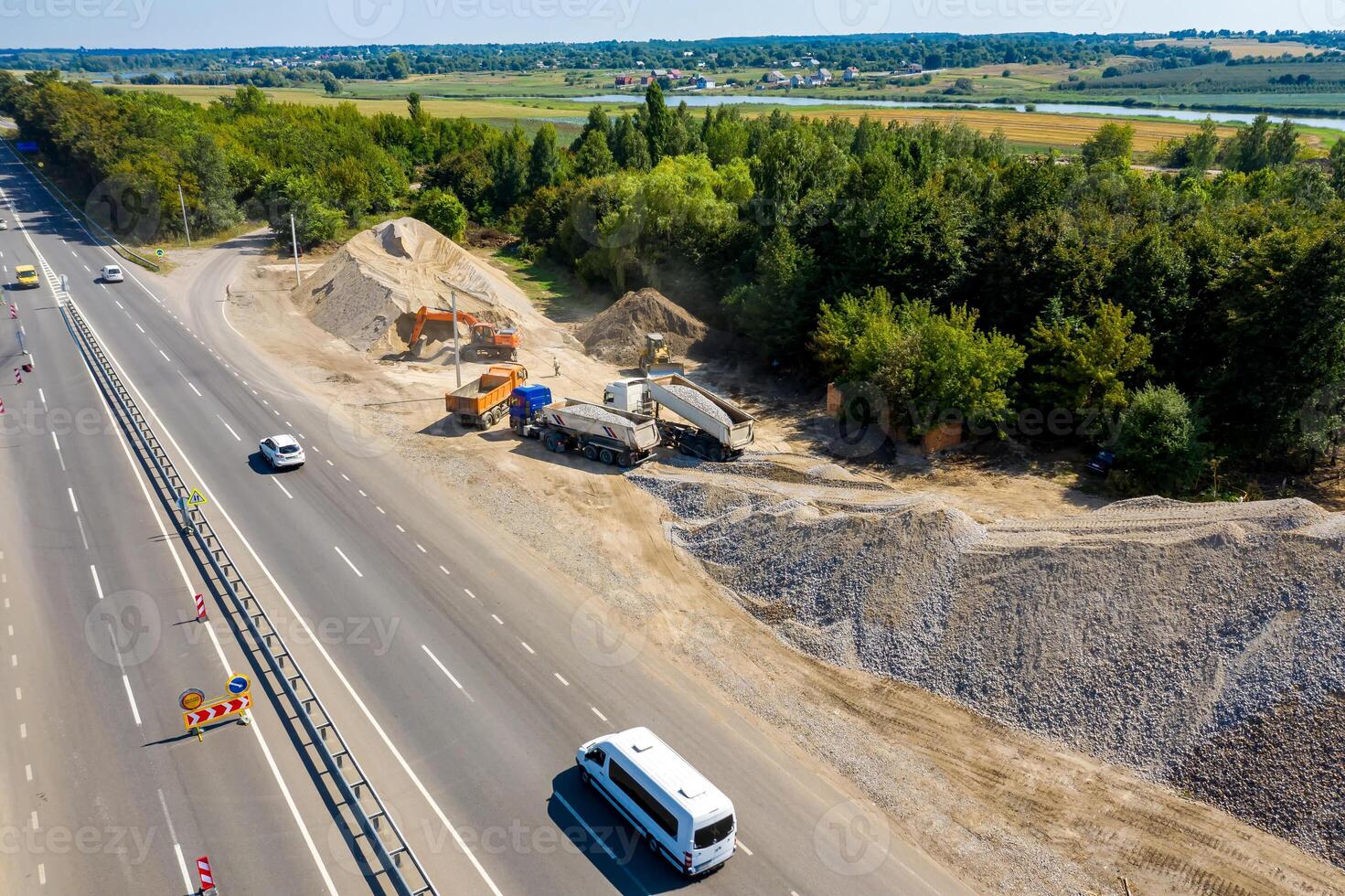Construction site. Construction of a plant for the production of asphalt. Heavy machinery on road. photo