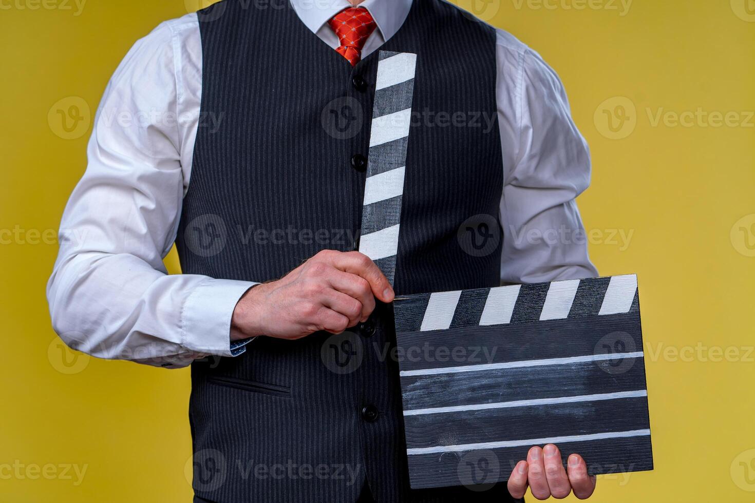 Man with movie flap while filming. Cropped photo. Film production. Human emotions. photo