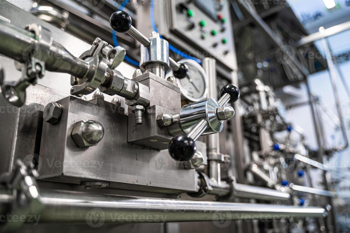 Production of yogurt and milk at dairy factory, industrial equipment for filling plastic cups and bottles. photo