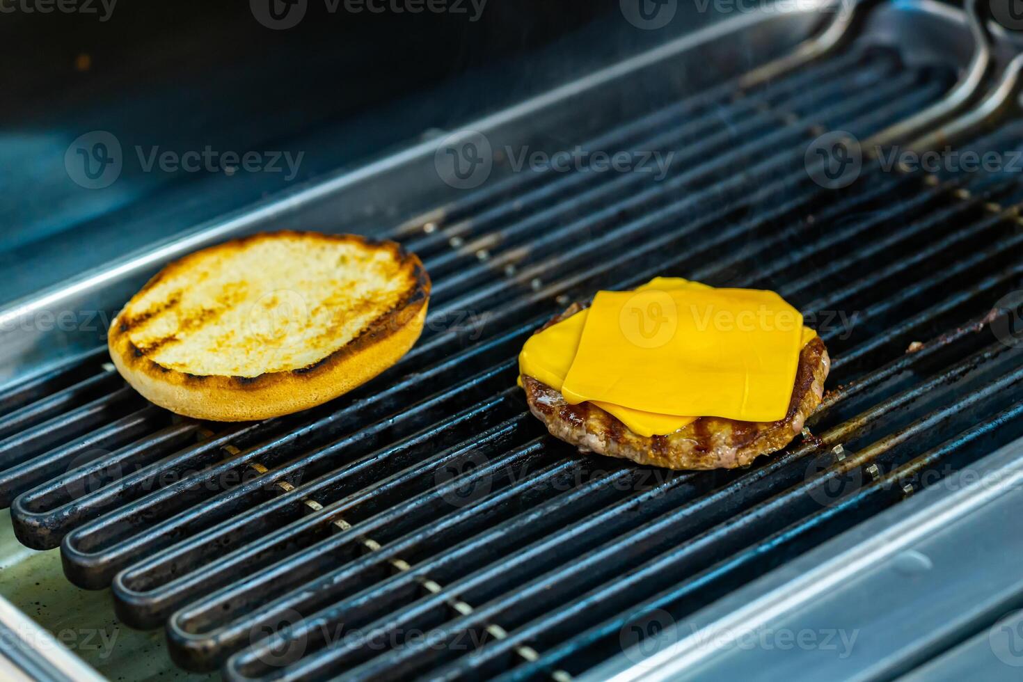 Cheese on cutlet grilling for cheeseburger. Grilling burger on mangal. photo
