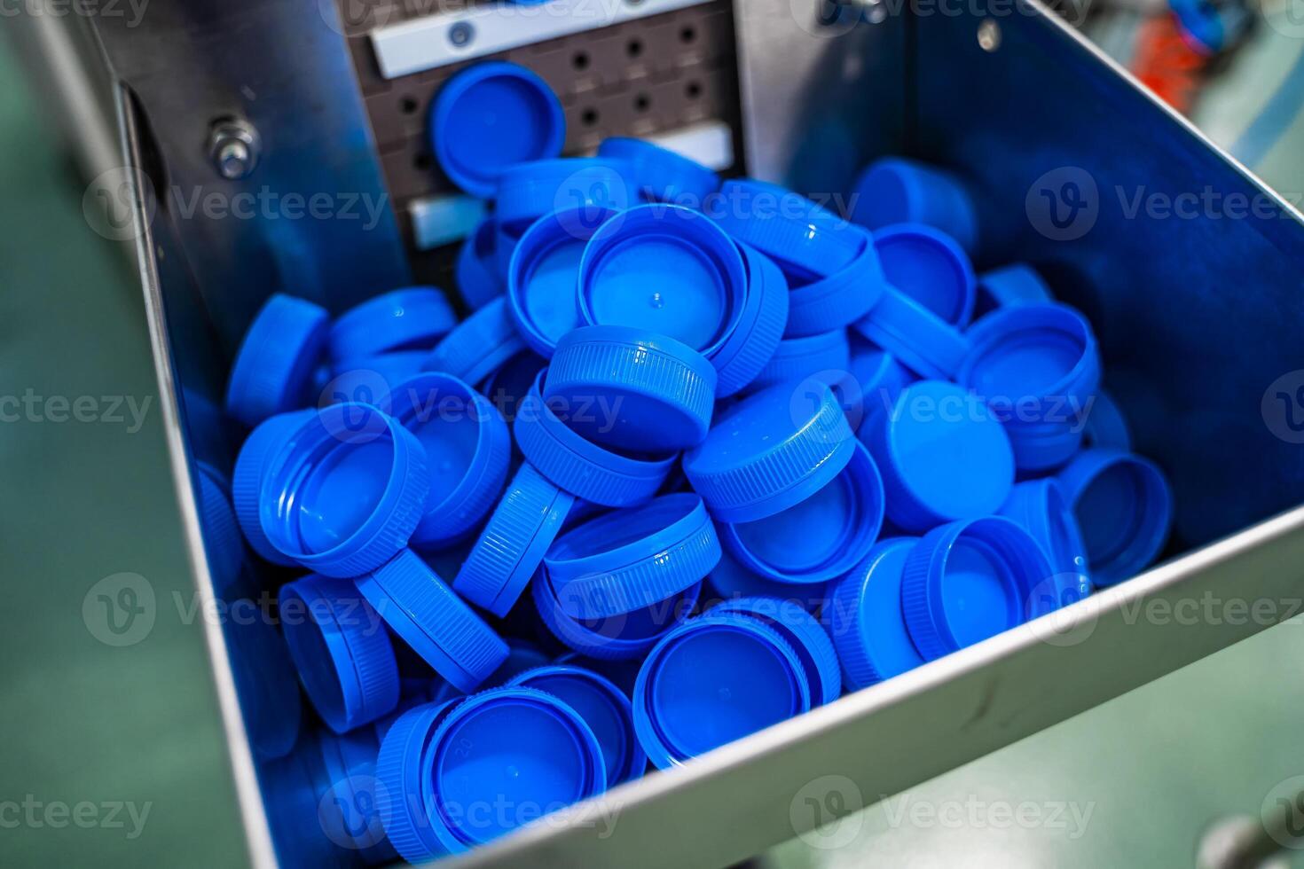 Bottling production. Plastic cups for bottles. Equipment at the dairy plant photo