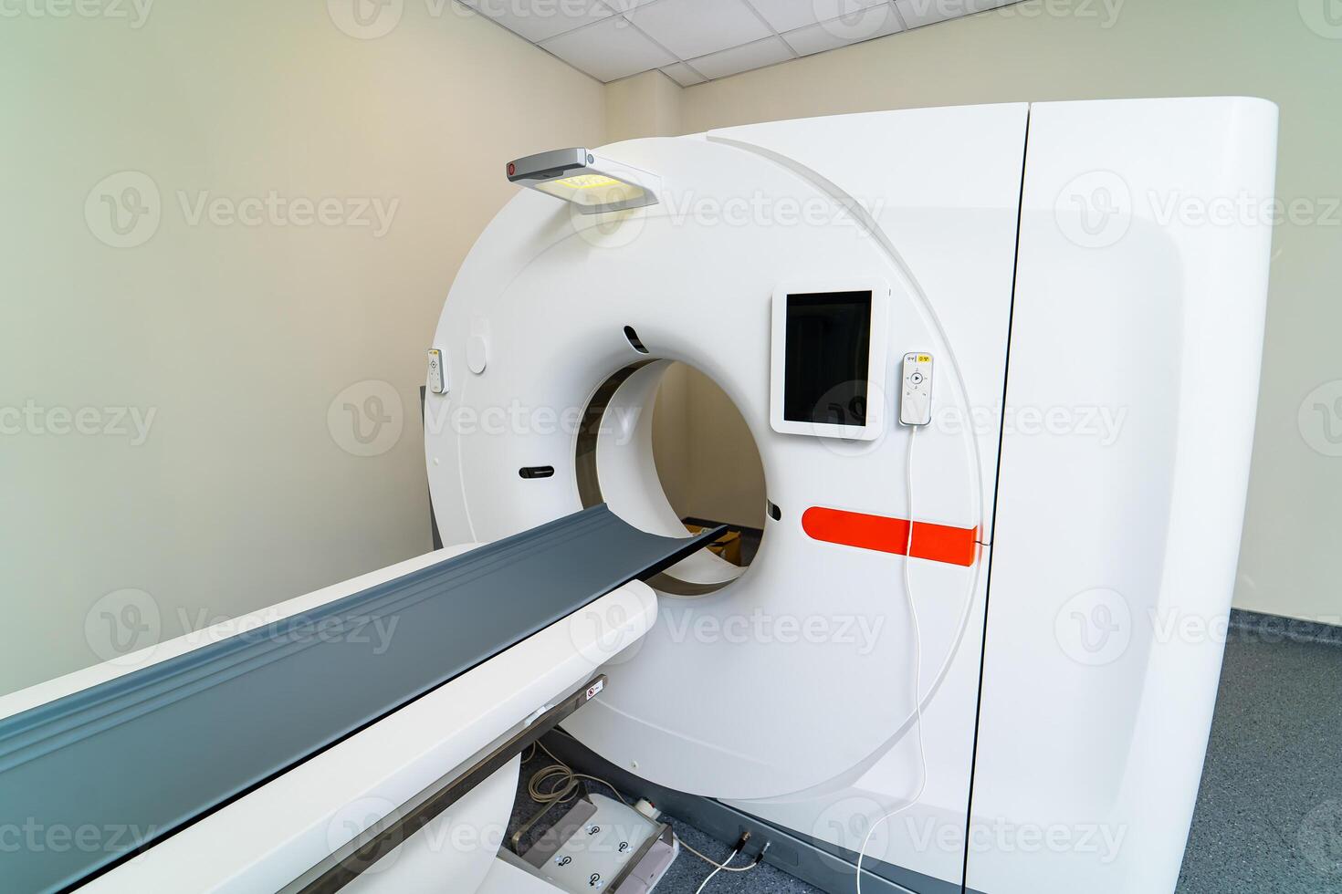 MRI machine is ready to research in a hospital room. Selective focus on medic equipment. No people in clinic room. photo