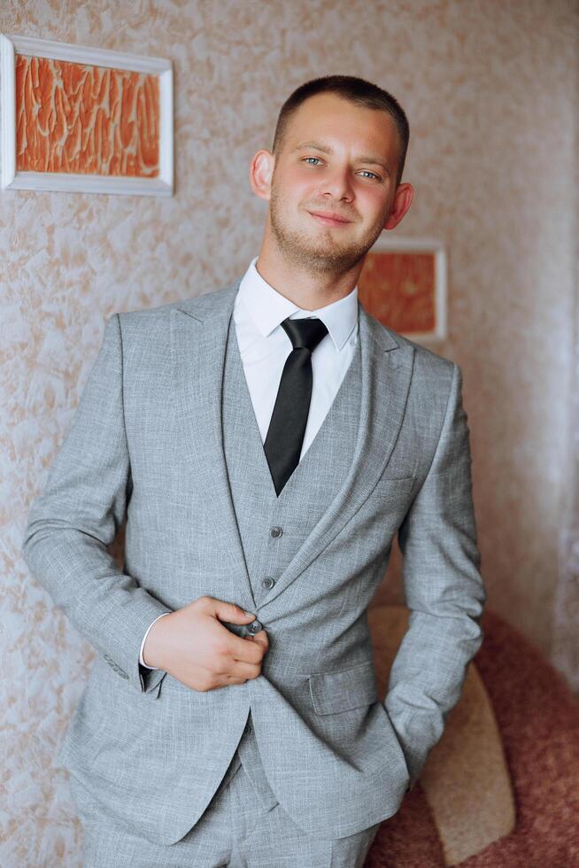 Portrait of smiling successful Caucasian man in formal suit, posing in room, happy young male boss or CEO looking at camera, showing confidence and strength, leadership concept photo