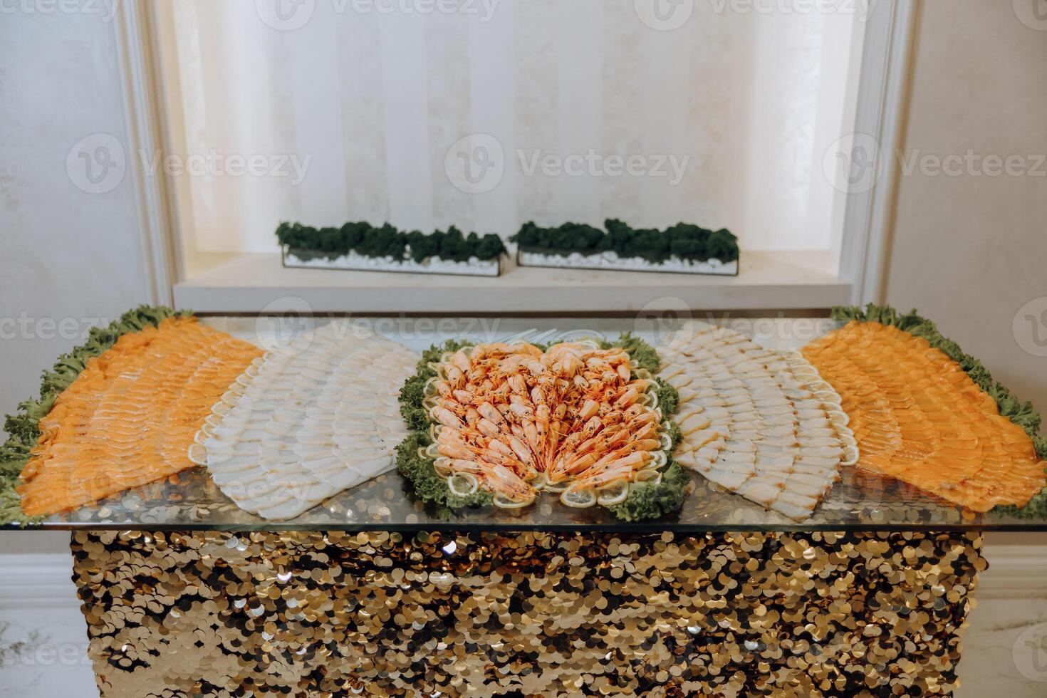 Sushi bar among catering banquet table. Variety of snacks, appetizers, seafood and cooked meals displayed as buffet for wedding, Christmas, business corporate, birthday party or other event photo