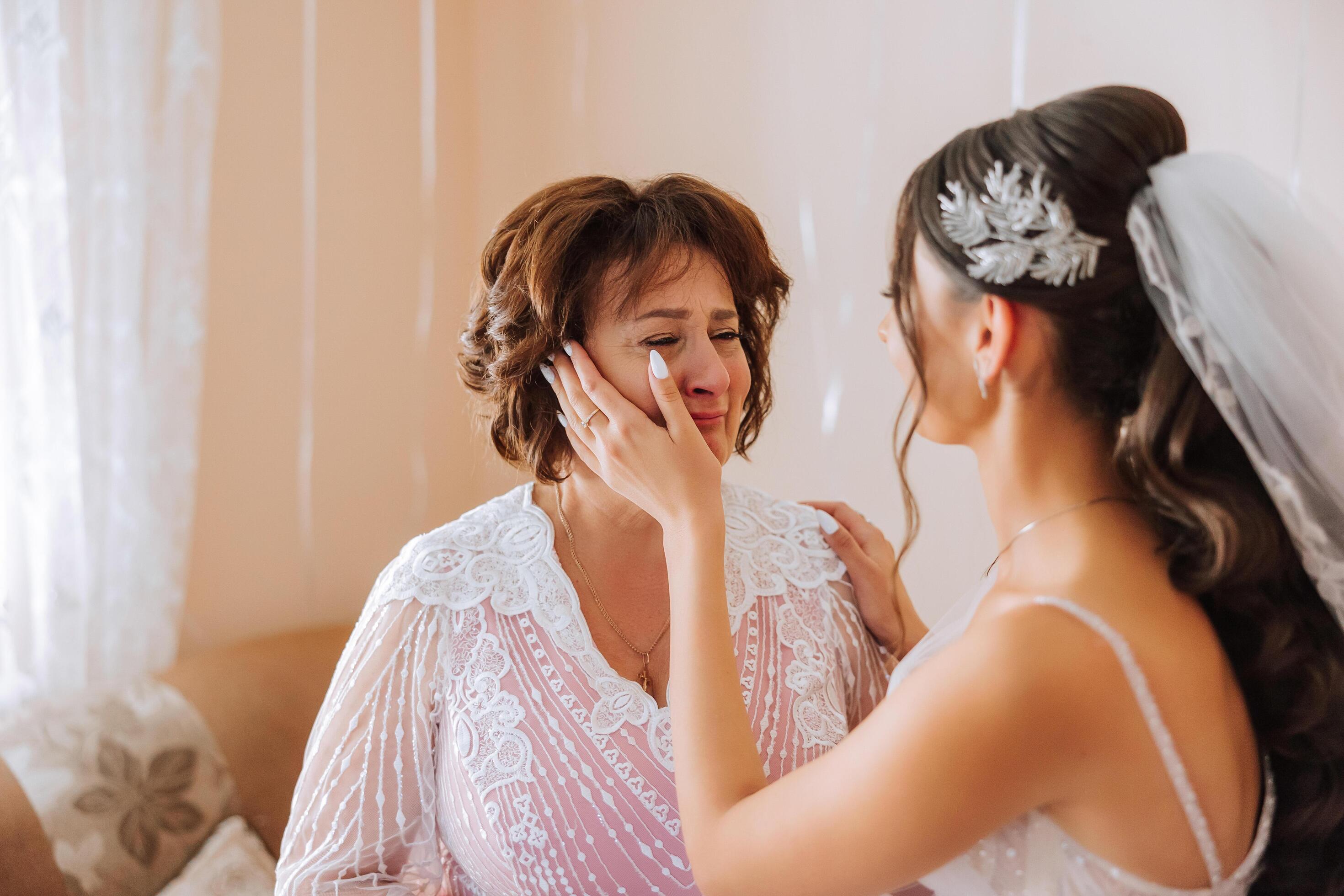 A beautiful and happy mother and her daughter, the bride, are standing next  to each other. The best day for parents. Tender moments at the wedding.  40859550 Stock Photo at Vecteezy