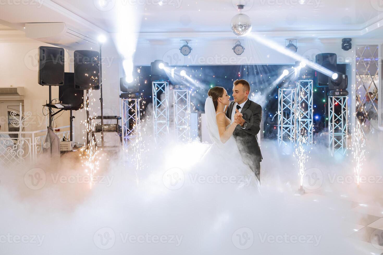 the wedding of the bride and groom in an elegant restaurant with great light and atmosphere. The first dance of the bride and groom. photo