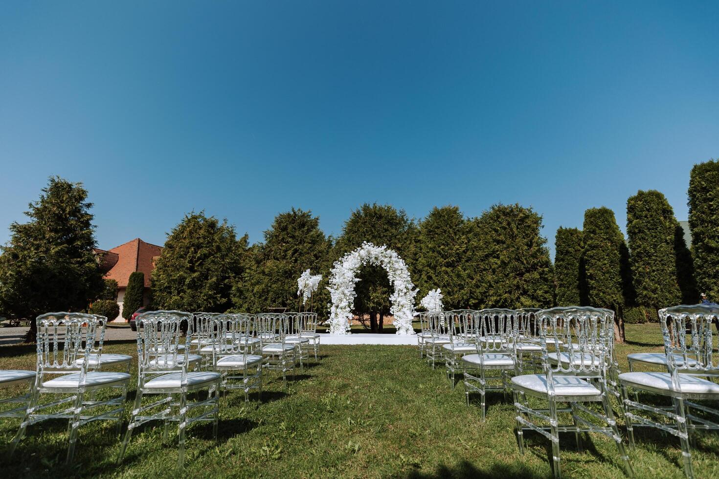 decoración a el boda. muchos transparente sillas en el verde césped. foto