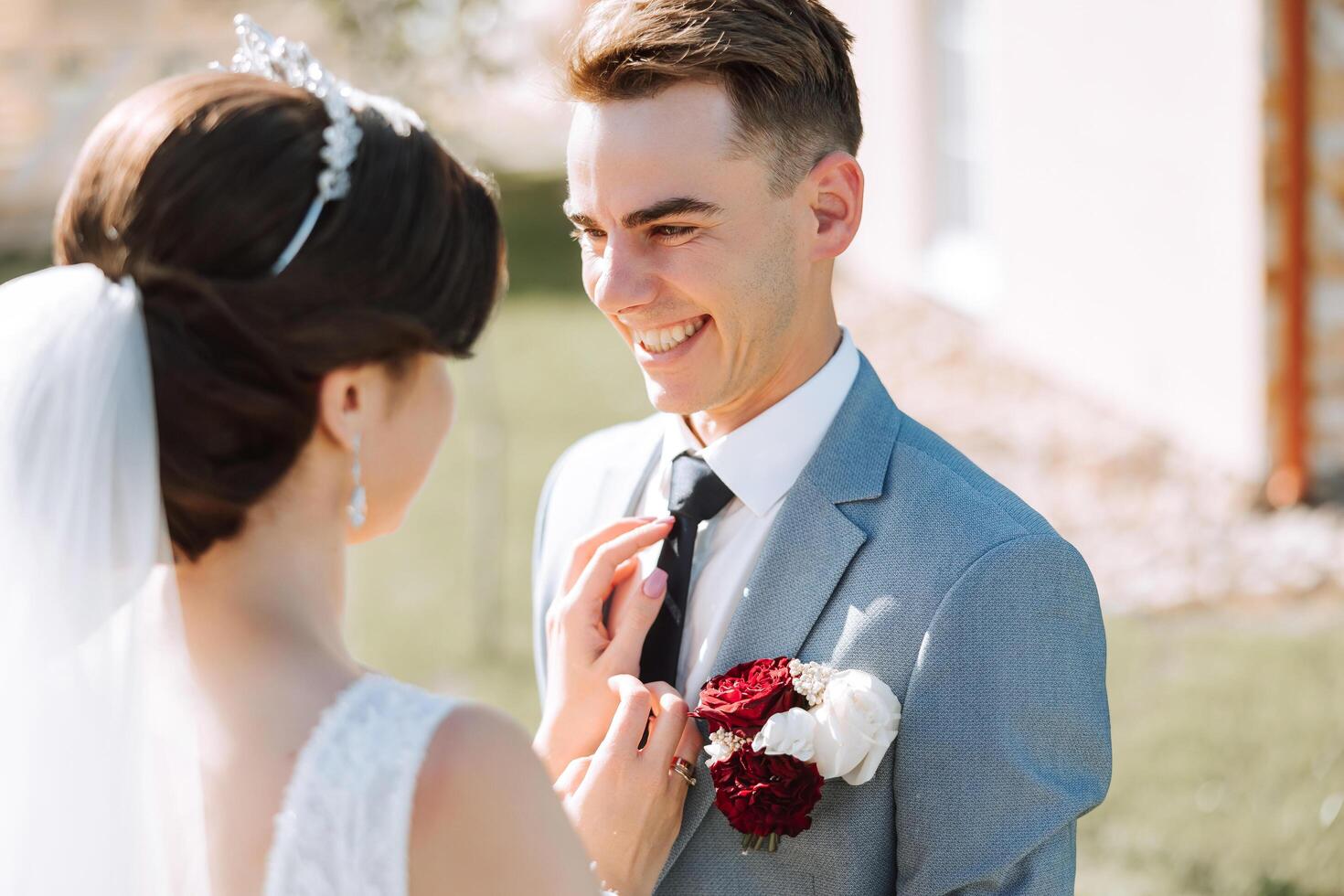 The bride and groom look at each other on their wedding day. Over the shoulder shot of a wedding couple. Tenderness and love in the eyes. photo