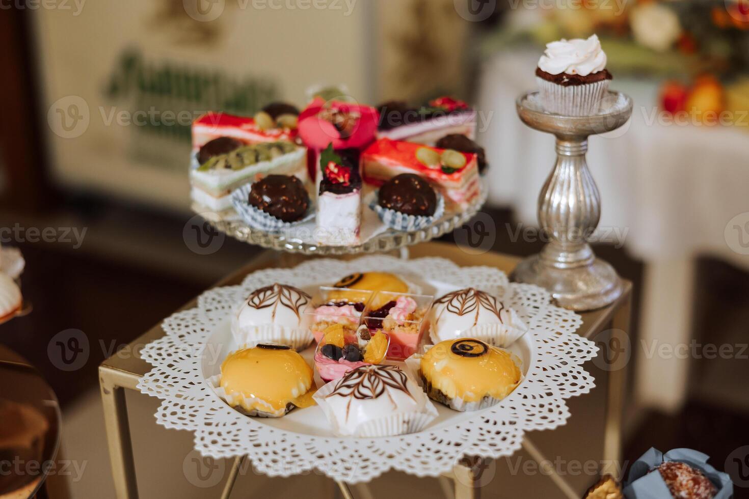 Almond cookies, sweet cakes for a wedding banquet. A delicious reception, a luxurious ceremony. Table with sweets and desserts. Delicious colorful French desserts on a plate or table. Candy bar. photo