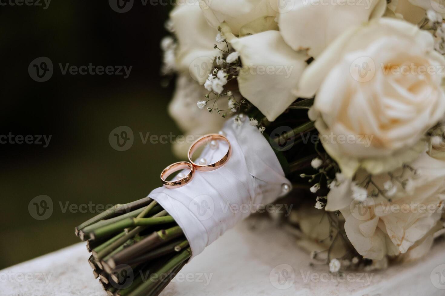 a wedding bouquet of white roses stands in nature photo
