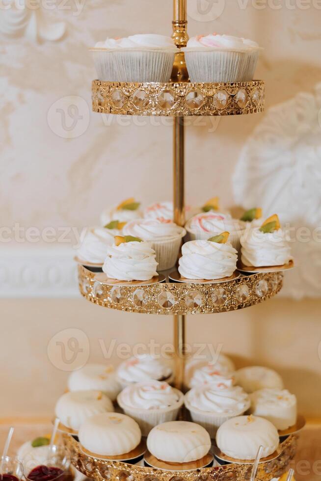 Almond cookies, sweet cakes for a wedding banquet. A delicious reception, a luxurious ceremony. Table with sweets and desserts. Delicious colorful French desserts on a plate or table. Candy bar. photo