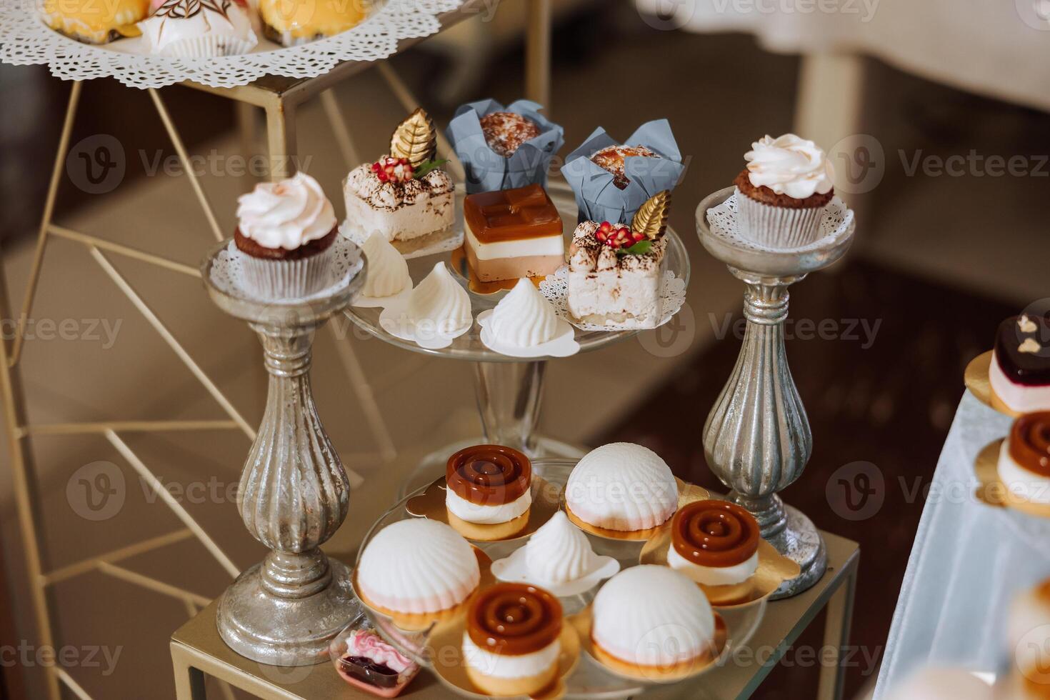 Almond cookies, sweet cakes for a wedding banquet. A delicious reception, a luxurious ceremony. Table with sweets and desserts. Delicious colorful French desserts on a plate or table. Candy bar. photo