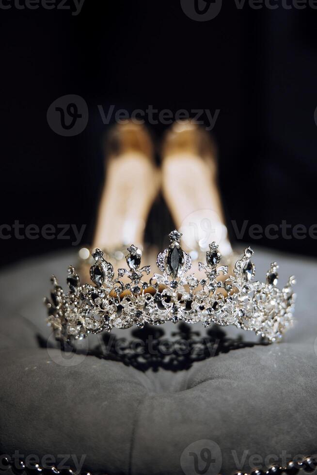 Miss Beauty Pageant Diamond Silver Crown, Crystal Tiara Jewellery, Embellished with Gemstones on Women's High Heel Shoes Background.. photo