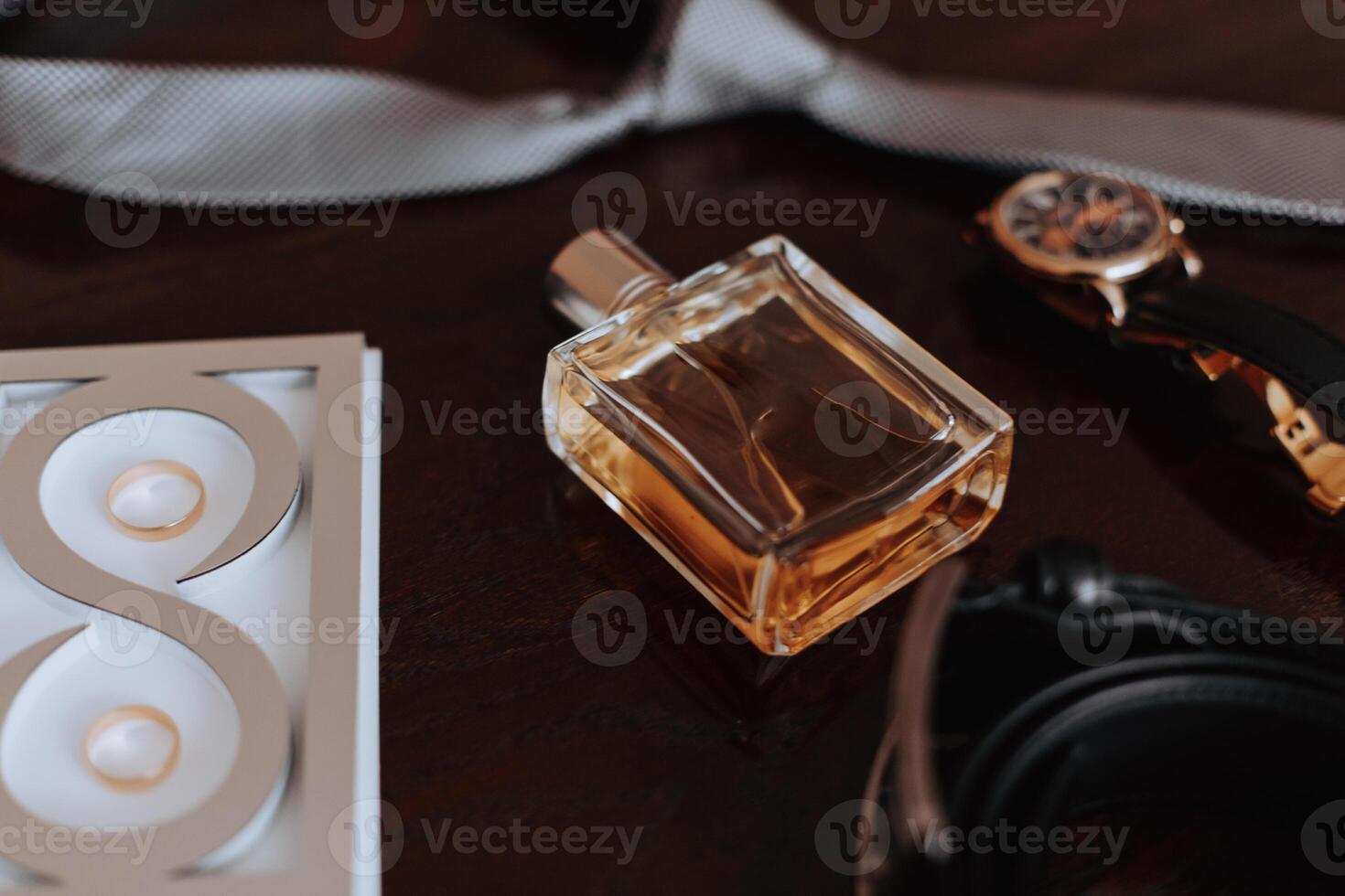 Men's accessories, groom details. Watch. Men's perfumes. Preparation for the wedding. Leather shoes. Gold wedding rings. bow tie Wedding bouquet of flowers. photo