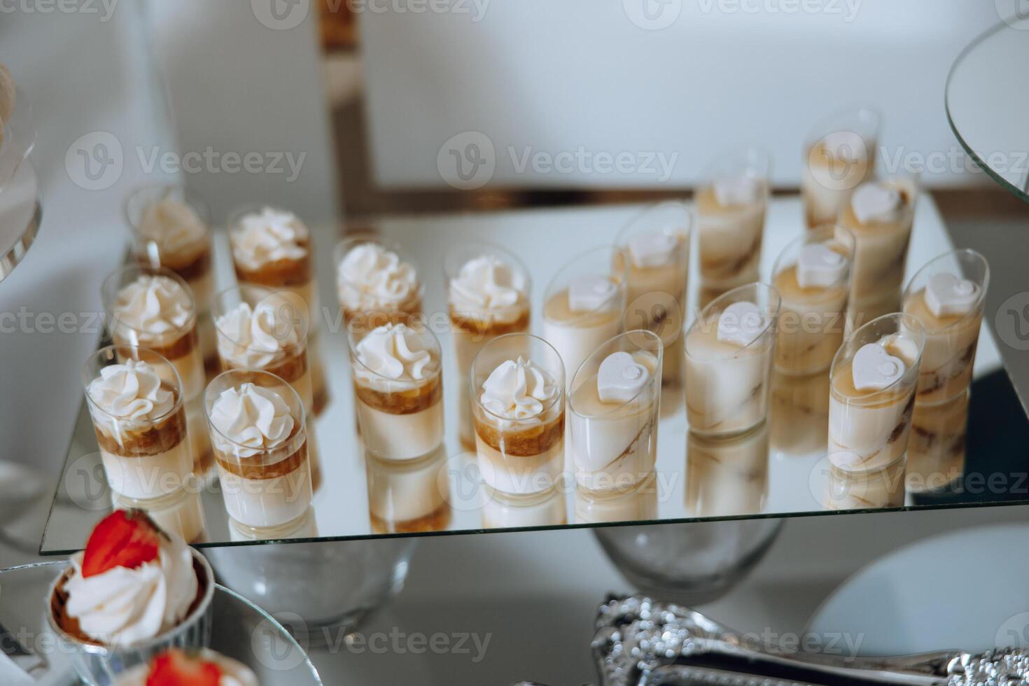 Almond cookies, sweet cakes for a wedding banquet. A delicious reception, a luxurious ceremony. Table with sweets and desserts. Delicious colorful French desserts on a plate or table. Candy bar. photo