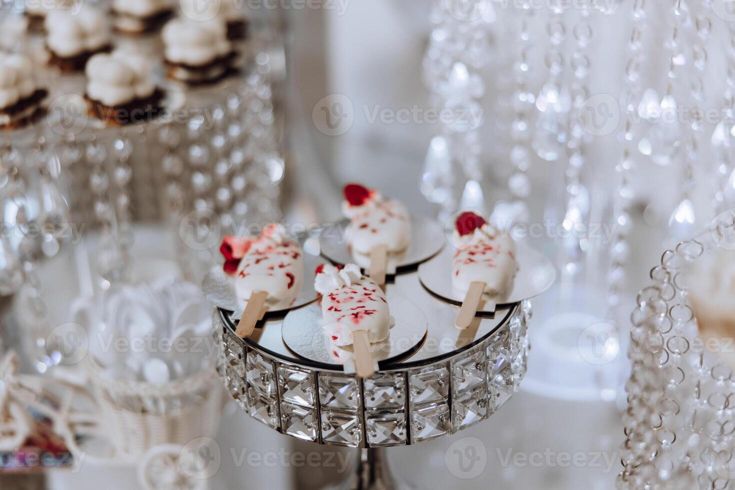 Almond cookies, sweet cakes for a wedding banquet. A delicious reception, a luxurious ceremony. Table with sweets and desserts. Delicious colorful French desserts on a plate or table. Candy bar. photo