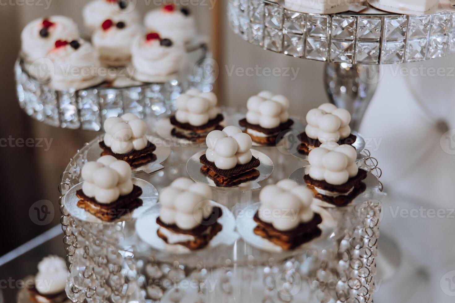 Almond cookies, sweet cakes for a wedding banquet. A delicious reception, a luxurious ceremony. Table with sweets and desserts. Delicious colorful French desserts on a plate or table. Candy bar. photo