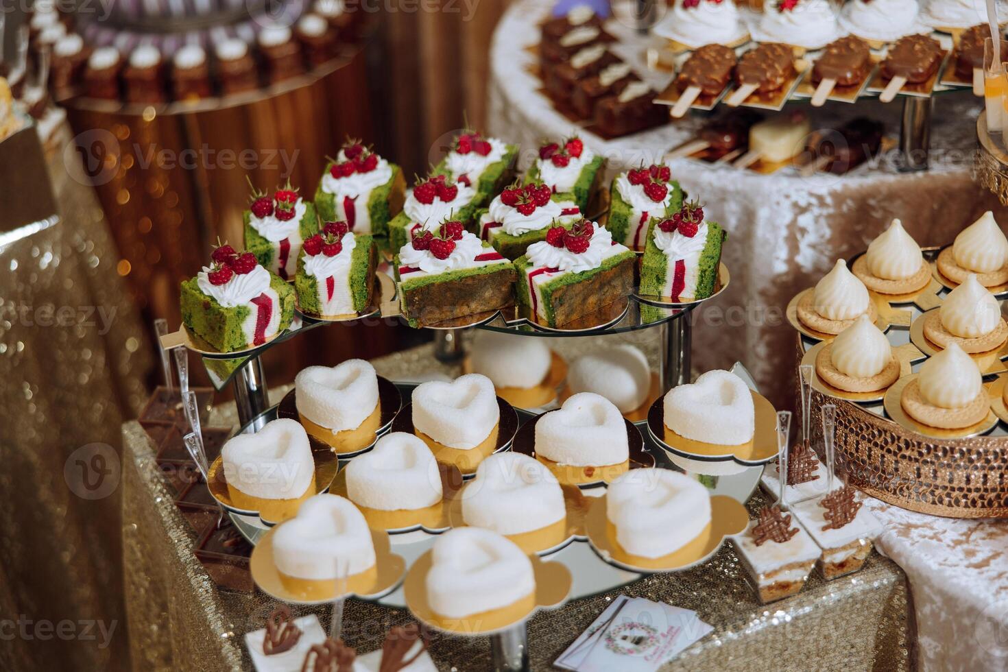 Almond cookies, sweet cakes for a wedding banquet. A delicious reception, a luxurious ceremony. Table with sweets and desserts. Delicious colorful French desserts on a plate or table. Candy bar. photo