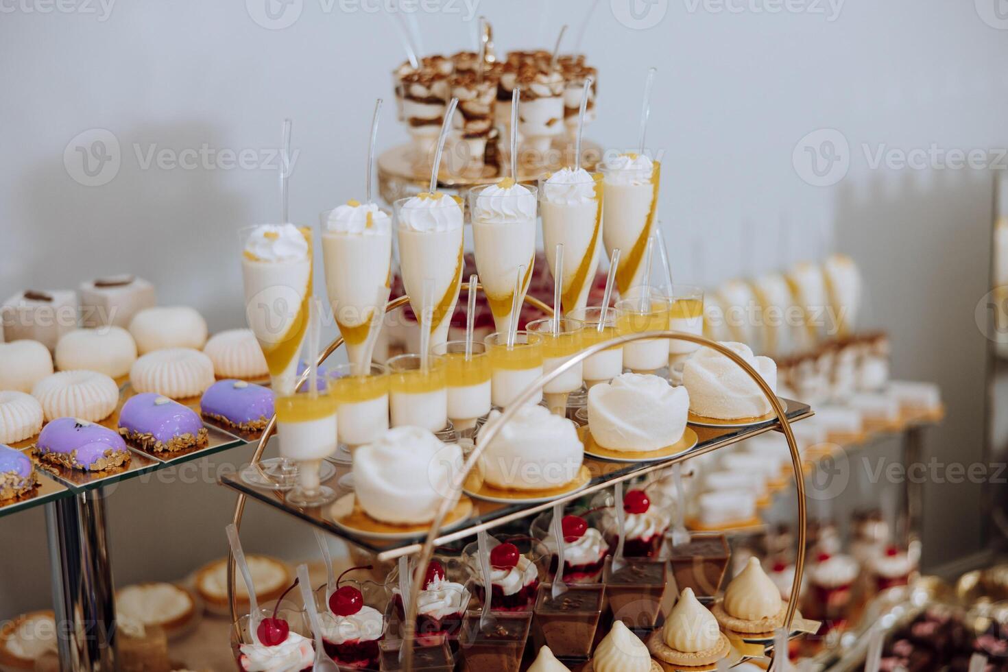 Almond cookies, sweet cakes for a wedding banquet. A delicious reception, a luxurious ceremony. Table with sweets and desserts. Delicious colorful French desserts on a plate or table. Candy bar. photo